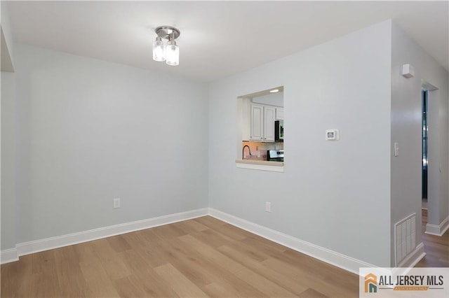 416 Wallace St Unit 416, Edison, NJ 08817 - spare room featuring light wood-style flooring and baseboards