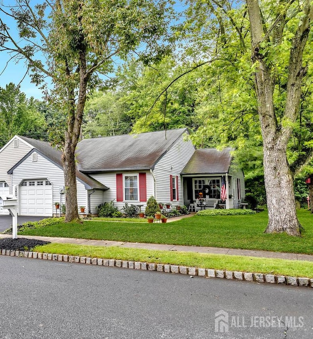 20 Sagamore Ave, Edison, NJ 08820 - view of front of house with a front lawn, asphalt driveway, a garage, and a shingled roof