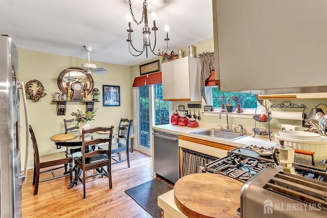 20 Sagamore Ave, Edison, NJ 08820 - kitchen featuring stainless steel appliances, light wood-style flooring, light countertops, a ceiling fan, and a chandelier