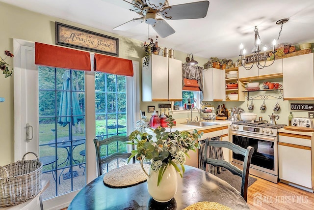 20 Sagamore Ave, Edison, NJ 08820 - kitchen with stainless steel gas stove, ceiling fan, plenty of natural light, and a chandelier