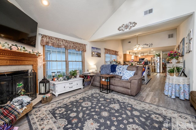 1617 Sweetbay Dr, Toms River, NJ 08755 - living area with wood finished floors, a glass covered fireplace, a ceiling fan, and high vaulted ceiling