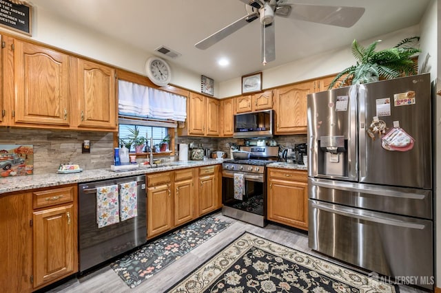 1617 Sweetbay Dr, Toms River, NJ 08755 - kitchen with stainless steel appliances, light wood finished floors, a ceiling fan, decorative backsplash, and recessed lighting