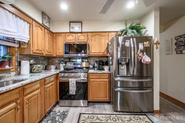 1617 Sweetbay Dr, Toms River, NJ 08755 - kitchen with appliances with stainless steel finishes, light wood finished floors, decorative backsplash, and light stone countertops