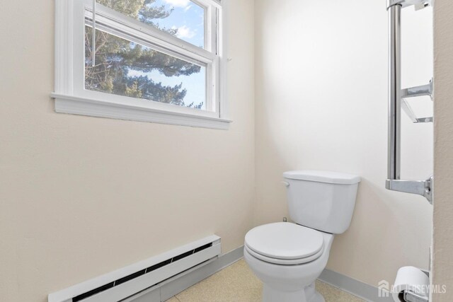 bathroom with baseboards, toilet, and baseboard heating