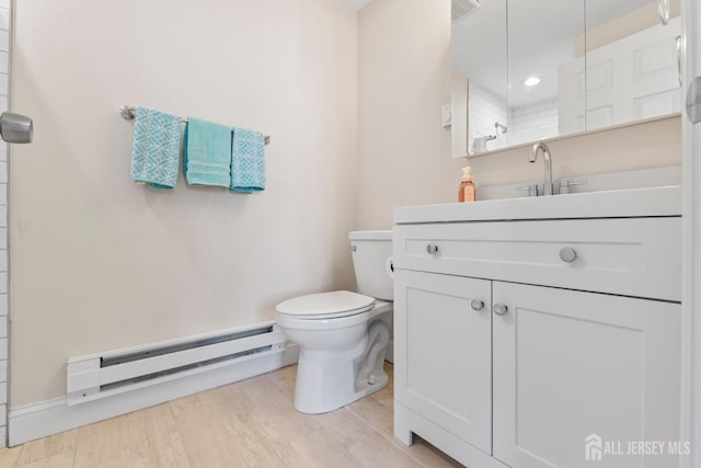 full bath featuring toilet, wood finished floors, visible vents, vanity, and baseboard heating