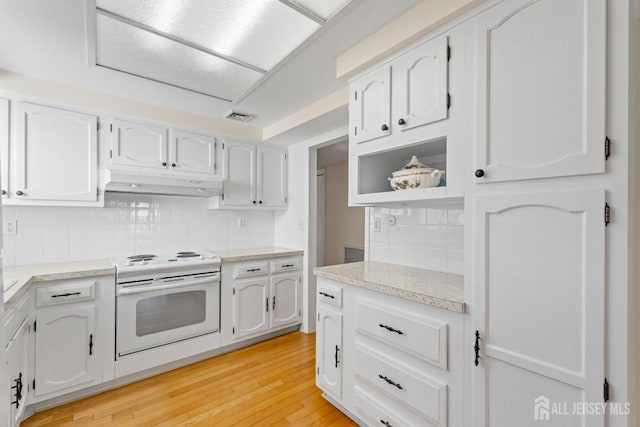 kitchen with light wood finished floors, visible vents, electric stove, under cabinet range hood, and white cabinetry