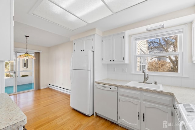 kitchen with a baseboard radiator, white appliances, a sink, white cabinetry, and light wood-style floors