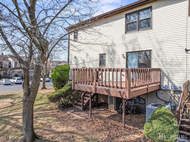back of house featuring a wooden deck, central AC, and stairs