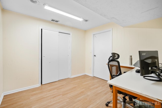 office space with light wood-style flooring and baseboards