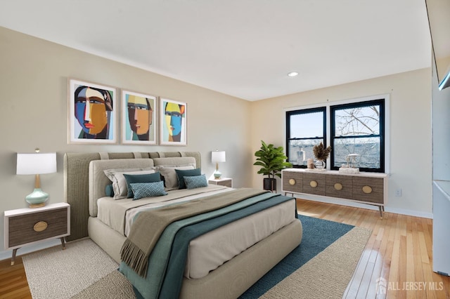 bedroom with light wood-style floors, baseboards, and recessed lighting