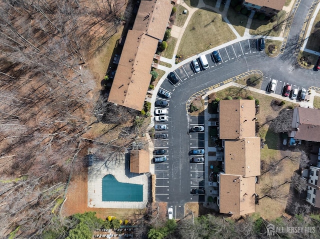 aerial view of property and surrounding area featuring a pool area