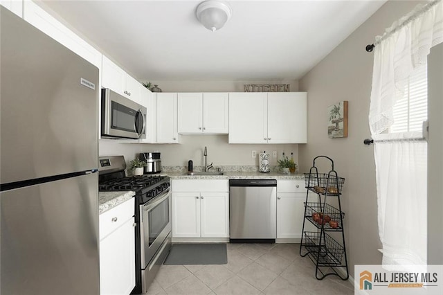 516 Great Beds Ct, Perth Amboy, NJ 08861 - kitchen with stainless steel appliances, a sink, white cabinets, and light tile patterned floors