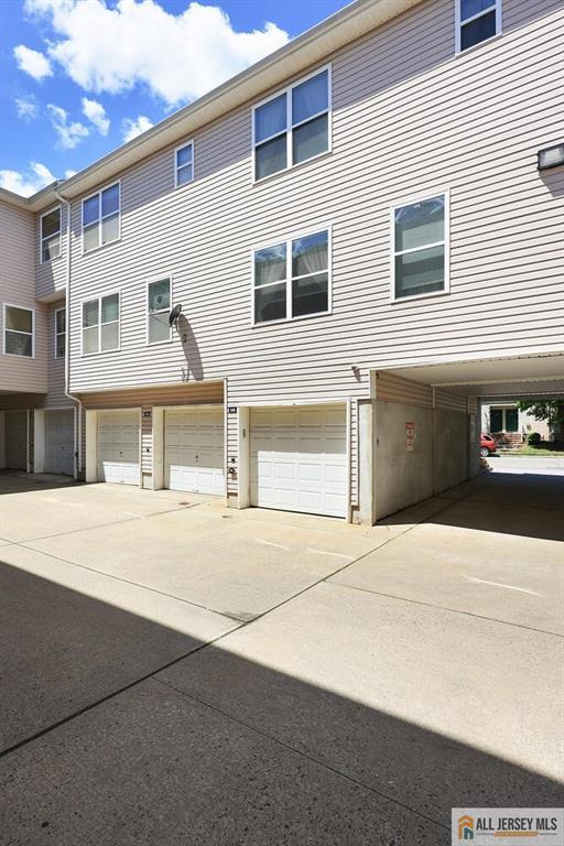 516 Great Beds Ct, Perth Amboy, NJ 08861 - view of front facade with an attached garage and driveway