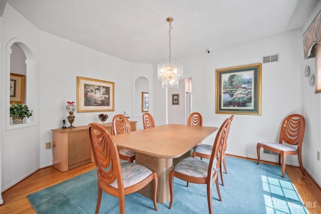 11 Wintons Way, Monroe, NJ 08831 - dining area with arched walkways, light wood-style flooring, and a chandelier
