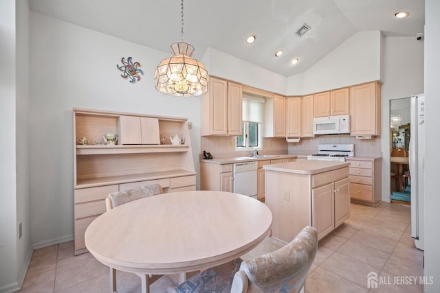 11 Wintons Way, Monroe, NJ 08831 - kitchen with white appliances, light brown cabinets, vaulted ceiling, light countertops, and decorative backsplash