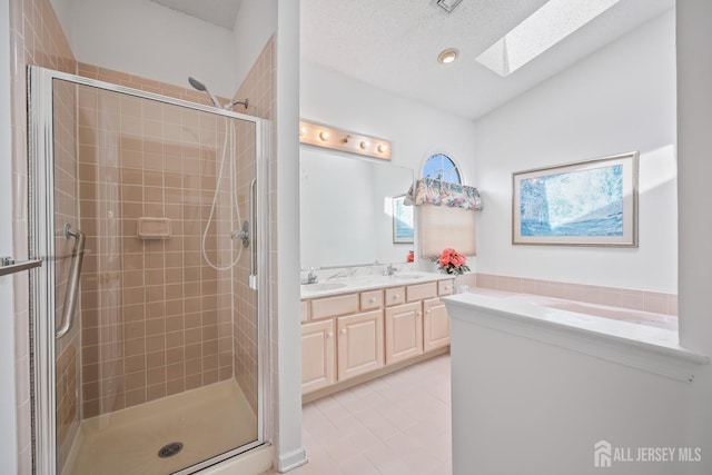11 Wintons Way, Monroe, NJ 08831 - full bathroom featuring a skylight, a stall shower, tile patterned floors, vaulted ceiling, and double vanity