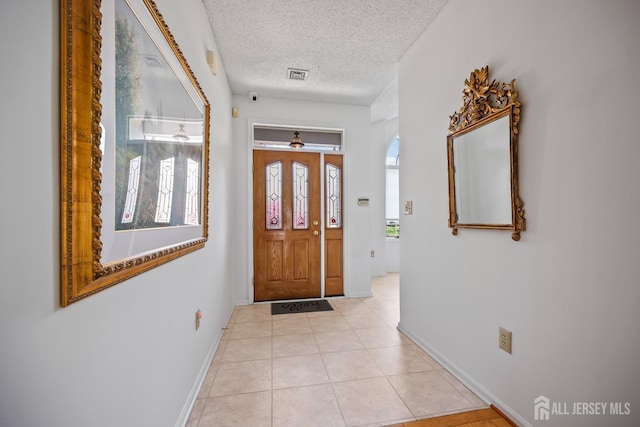 11 Wintons Way, Monroe, NJ 08831 - foyer entrance with baseboards, a textured ceiling, light tile patterned flooring, and arched walkways