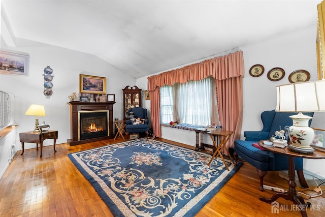 25 Turner Ave, Edison, NJ 08820 - living room with vaulted ceiling, a glass covered fireplace, and hardwood / wood-style floors