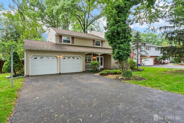 25 Turner Ave, Edison, NJ 08820 - view of front of property with asphalt driveway, a front lawn, covered porch, and an attached garage