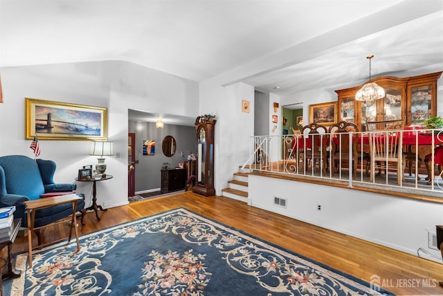 25 Turner Ave, Edison, NJ 08820 - living area with wood finished floors, stairs, a chandelier, vaulted ceiling, and baseboards