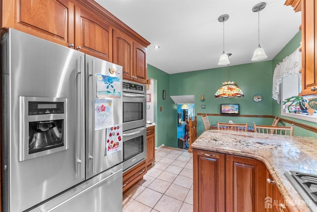 25 Turner Ave, Edison, NJ 08820 - kitchen with stainless steel appliances, brown cabinets, light tile patterned floors, decorative light fixtures, and light stone countertops