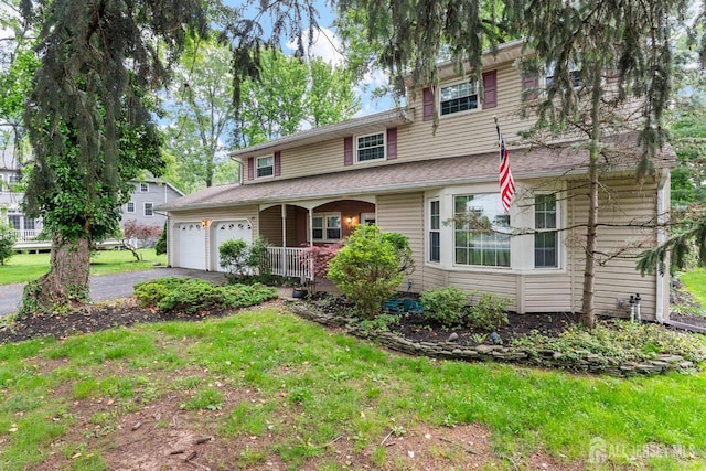 25 Turner Ave, Edison, NJ 08820 - traditional-style home with a porch, asphalt driveway, a garage, and a front yard
