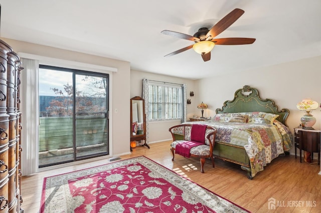 bedroom with light hardwood / wood-style floors, ceiling fan, and access to outside