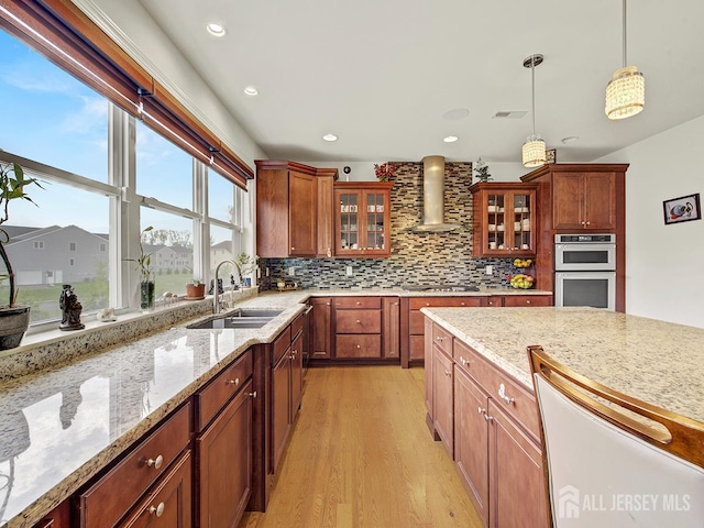 6 Condor Ct, South Brunswick, NJ 08852 - kitchen with a sink, wall chimney exhaust hood, stainless steel appliances, light wood-style flooring, and decorative light fixtures
