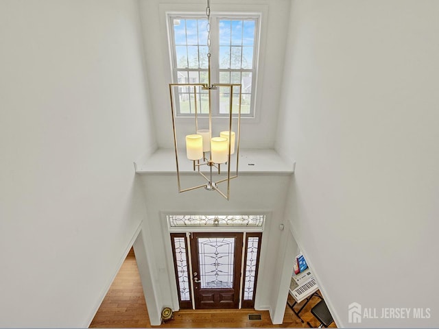 6 Condor Ct, South Brunswick, NJ 08852 - foyer entrance featuring a chandelier, wood finished floors, and a towering ceiling
