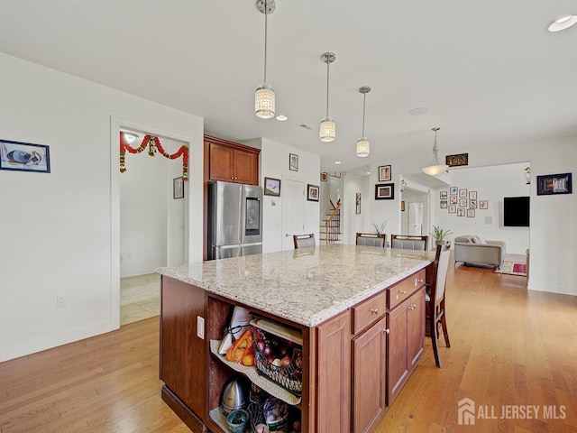 6 Condor Ct, South Brunswick, NJ 08852 - kitchen with smart refrigerator, light wood-type flooring, pendant lighting, light stone countertops, and a center island