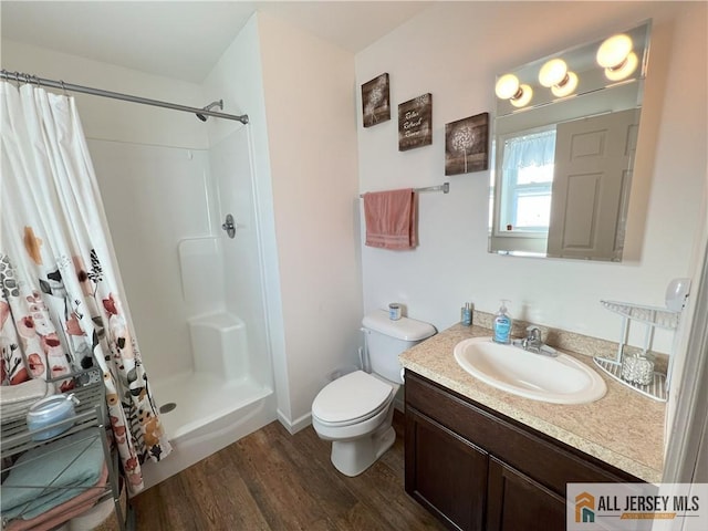 full bath with curtained shower, vanity, toilet, and wood finished floors