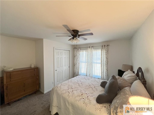 bedroom featuring a closet, baseboards, carpet, and a ceiling fan