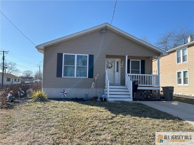 view of front of home with a porch and a front yard