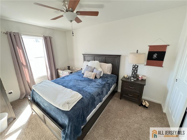 bedroom featuring carpet flooring, a ceiling fan, and baseboards