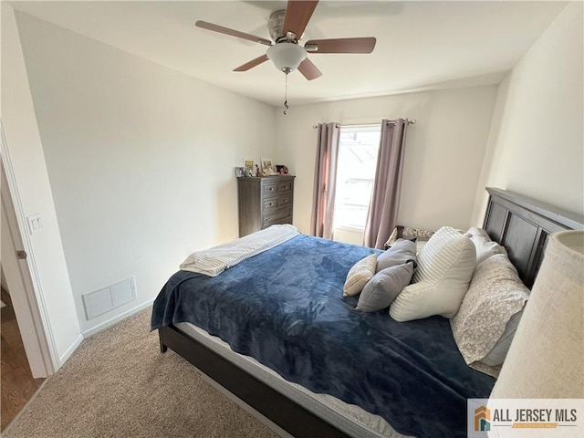 bedroom with visible vents, baseboards, carpet floors, and ceiling fan