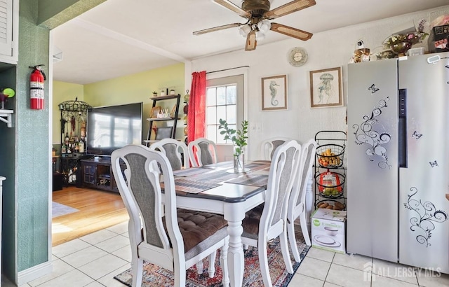 dining room with light tile patterned floors and a ceiling fan