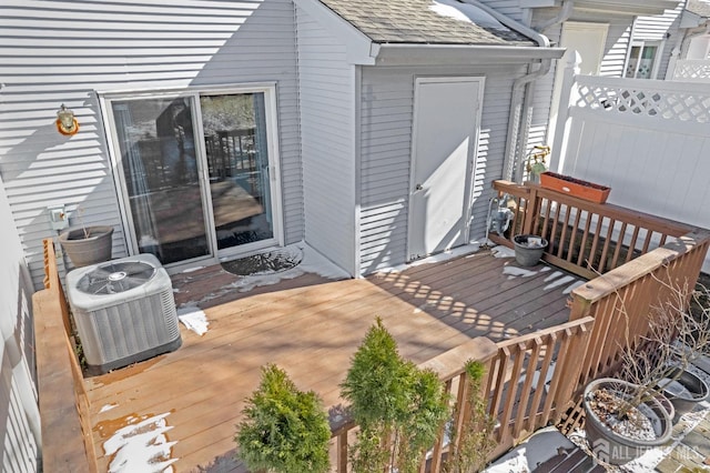 deck featuring central air condition unit and fence