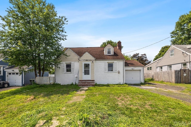 new england style home with a garage and a front yard