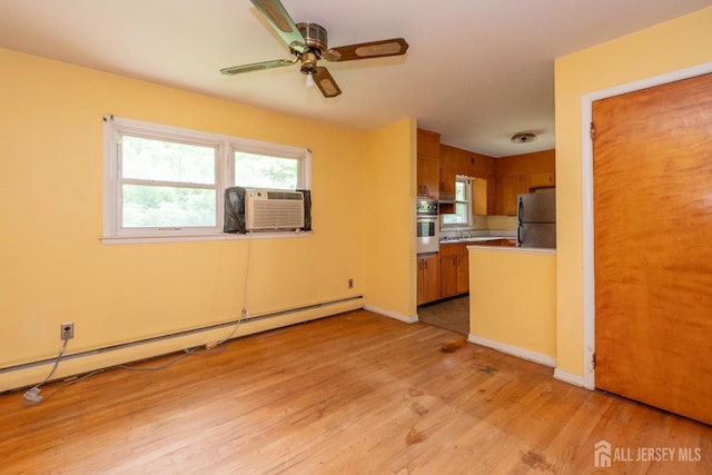 140 Prospect Plains Rd, Monroe, NJ 08831 - kitchen with freestanding refrigerator, a baseboard heating unit, light wood-style flooring, brown cabinetry, and a ceiling fan