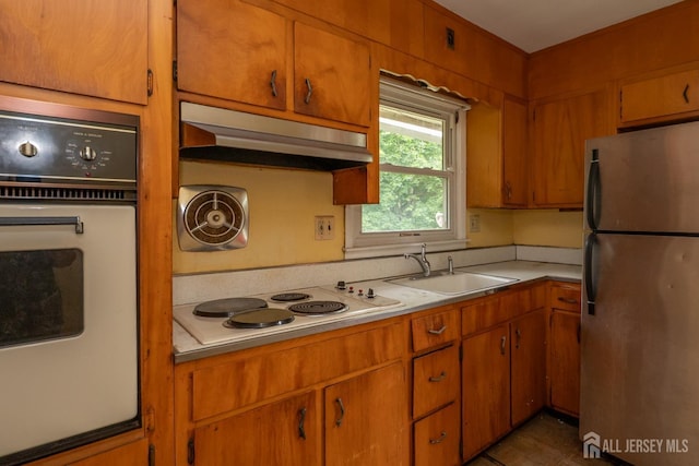 140 Prospect Plains Rd, Monroe, NJ 08831 - kitchen with freestanding refrigerator, electric stovetop, white oven, under cabinet range hood, and light countertops