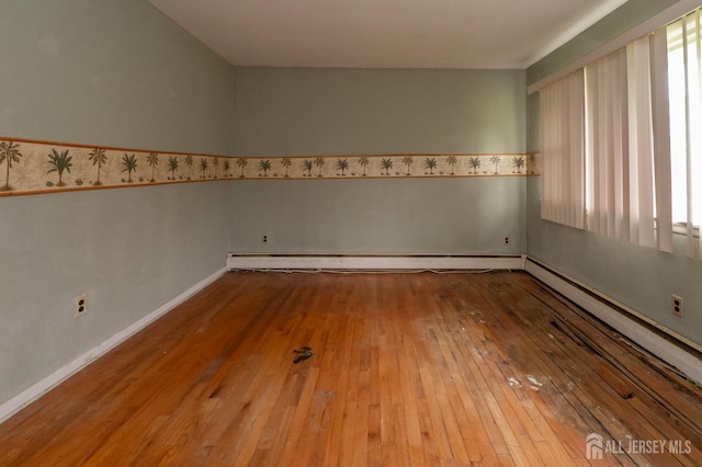 140 Prospect Plains Rd, Monroe, NJ 08831 - unfurnished room with wood-type flooring, plenty of natural light, and a baseboard radiator