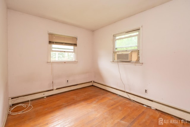 140 Prospect Plains Rd, Monroe, NJ 08831 - empty room with light wood finished floors, cooling unit, and baseboard heating