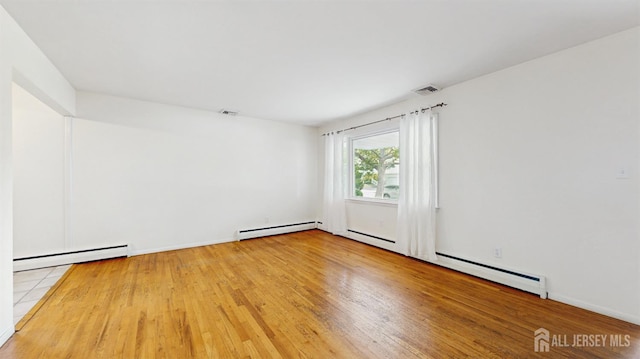 131 Hazelwood Ave, Metuchen, NJ 08840 - empty room featuring a baseboard radiator and wood finished floors