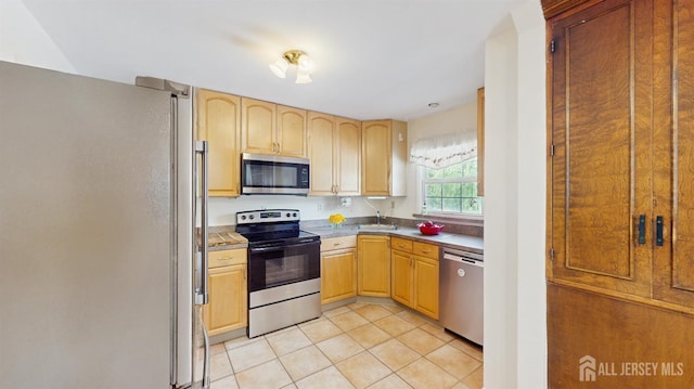 131 Hazelwood Ave, Metuchen, NJ 08840 - kitchen with stainless steel appliances, light tile patterned flooring, light brown cabinetry, and light countertops