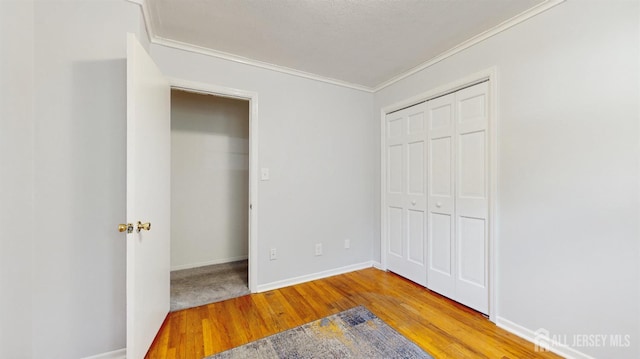 131 Hazelwood Ave, Metuchen, NJ 08840 - unfurnished bedroom featuring ornamental molding, wood finished floors, and a closet