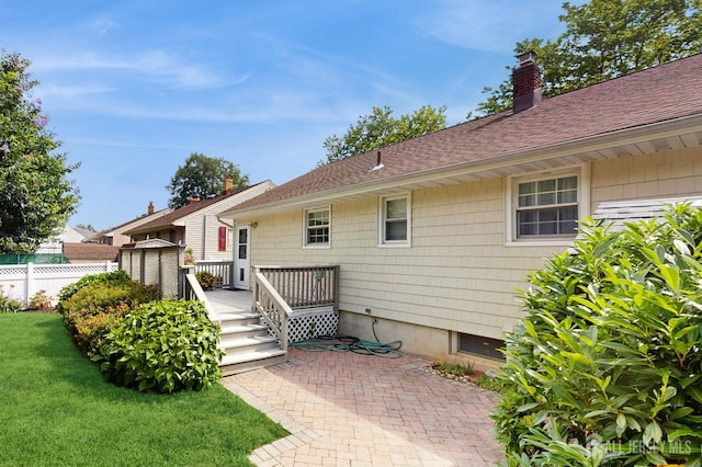 131 Hazelwood Ave, Metuchen, NJ 08840 - rear view of property featuring a chimney, a deck, and roof with shingles