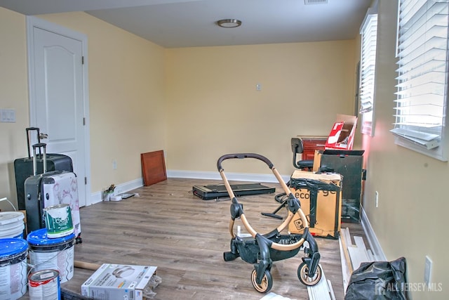 workout area with wood finished floors and baseboards