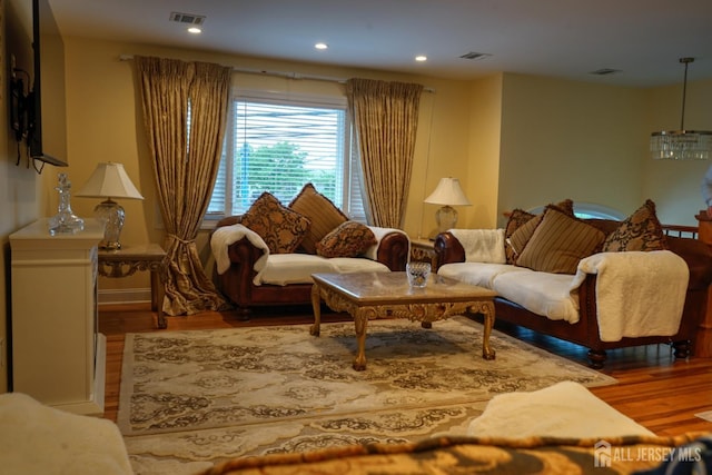 living area featuring wood finished floors and recessed lighting