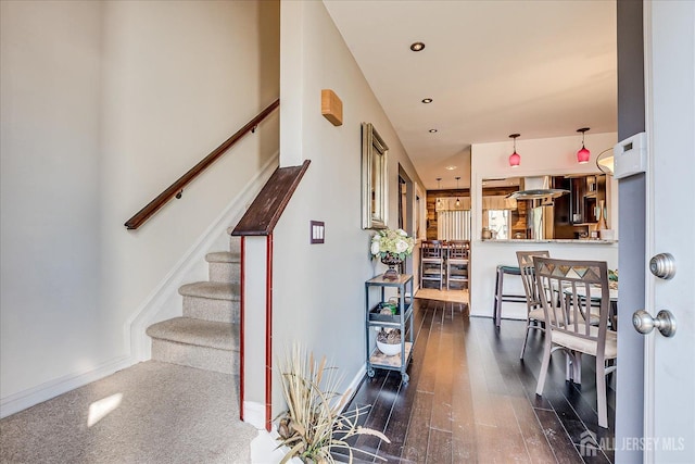 staircase with recessed lighting, baseboards, and wood finished floors