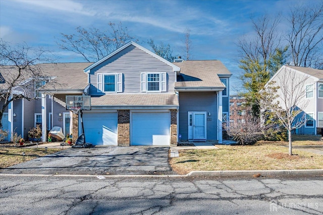 view of front of property with aphalt driveway, brick siding, a shingled roof, and an attached garage